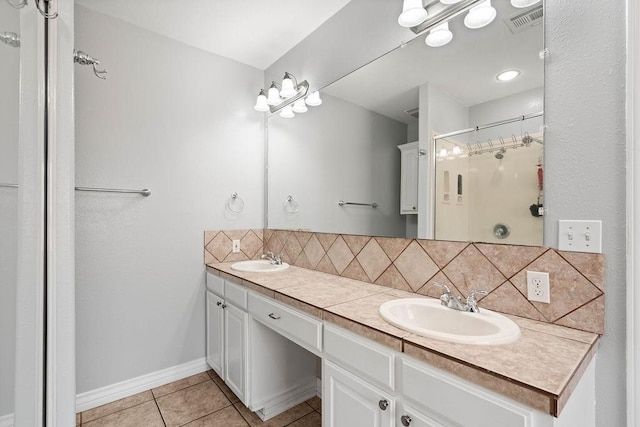 2214 N Mccampbell St, Aransas Pass, TX 78336 - bathroom with backsplash, a shower stall, double vanity, and tile patterned floors