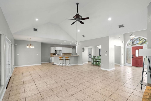 2214 N Mccampbell St, Aransas Pass, TX 78336 - unfurnished living room with a chandelier, high vaulted ceiling, light tile patterned flooring, ceiling fan, and recessed lighting