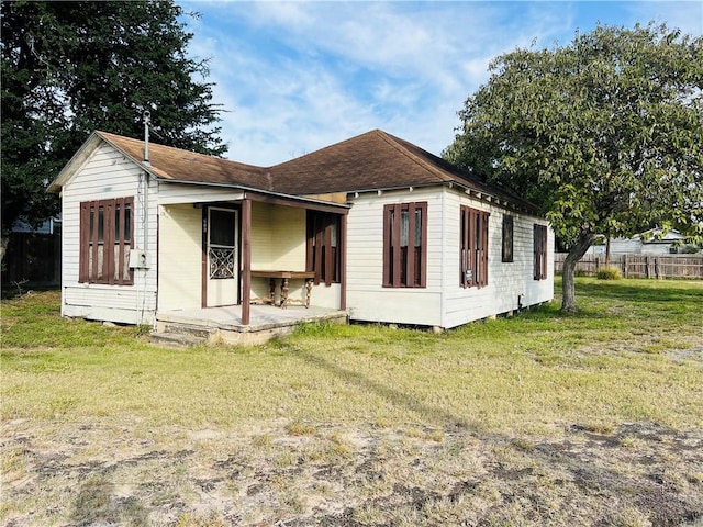 back of property featuring a lawn