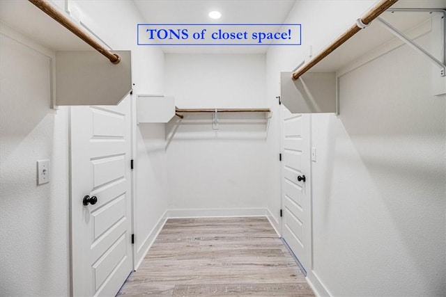 spacious closet featuring light wood finished floors