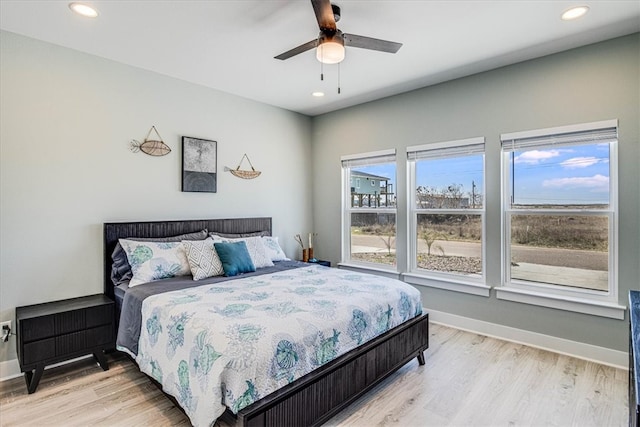 bedroom with light wood-style floors, baseboards, and recessed lighting