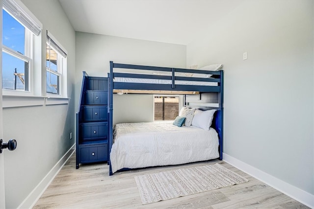 bedroom with light wood-style floors and baseboards