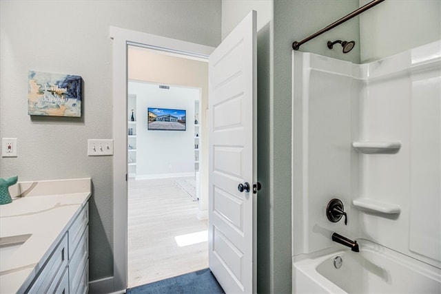 full bathroom featuring baseboards, visible vents, shower / bathtub combination, wood finished floors, and vanity