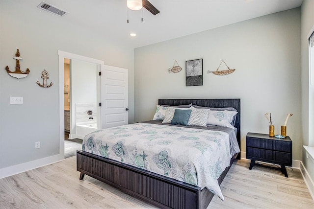 bedroom featuring light wood finished floors, visible vents, and baseboards