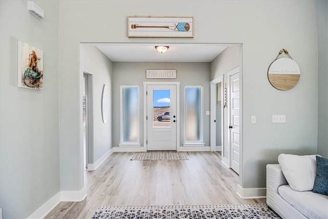 entrance foyer featuring light wood-style floors and baseboards