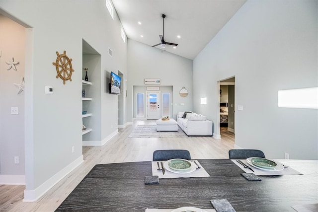 workout area featuring a ceiling fan, built in shelves, high vaulted ceiling, and wood finished floors