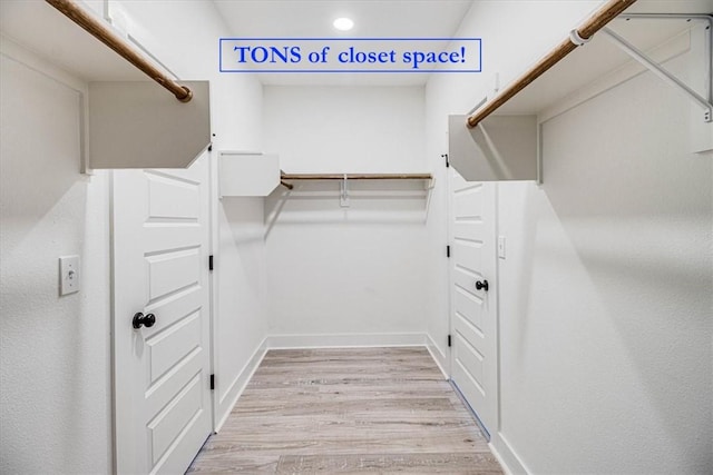 spacious closet with wood finished floors