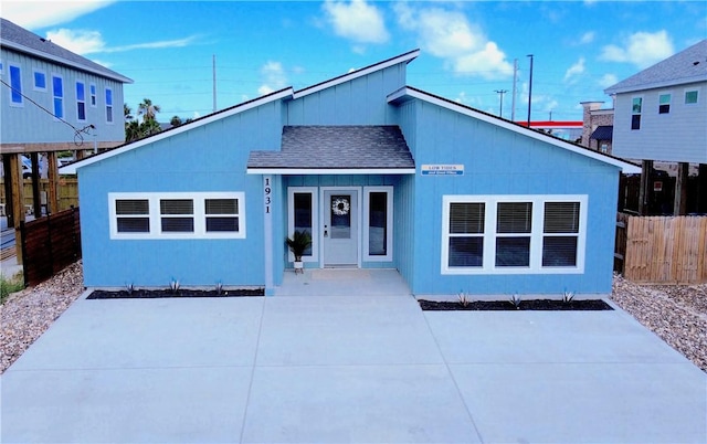 1931 Eskridge St, Port Aransas, TX 78373 - view of front of house featuring roof with shingles and a patio area