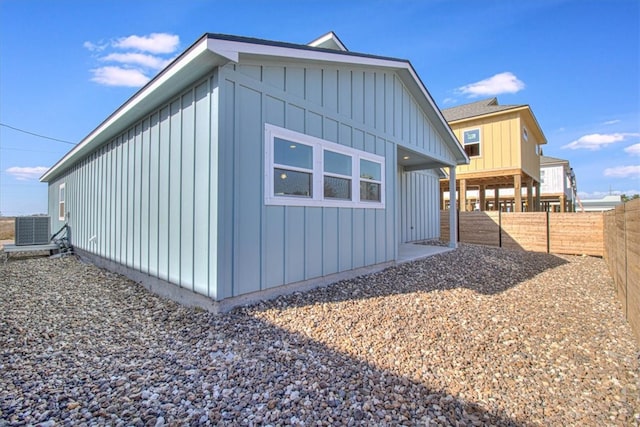 view of home's exterior featuring central AC, board and batten siding, and a fenced backyard