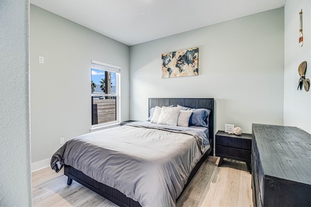 bedroom with baseboards and wood finished floors