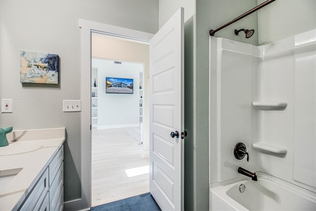 1931 Eskridge St, Port Aransas, TX 78373 - bathroom featuring shower / washtub combination, wood finished floors, vanity, and a textured wall