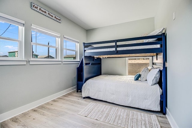 bedroom with baseboards and wood finished floors