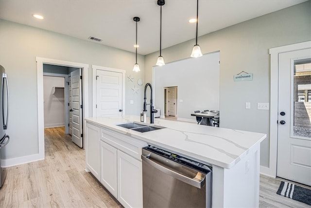 kitchen with stainless steel appliances, a sink, visible vents, white cabinetry, and light stone countertops