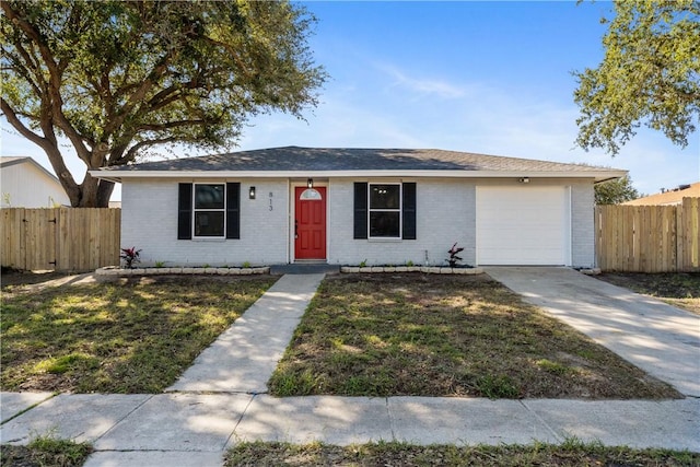 ranch-style home with a front yard and a garage