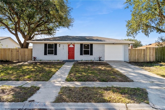 ranch-style house featuring a front lawn and a garage