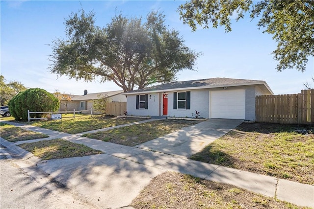 ranch-style house featuring a garage and a front yard