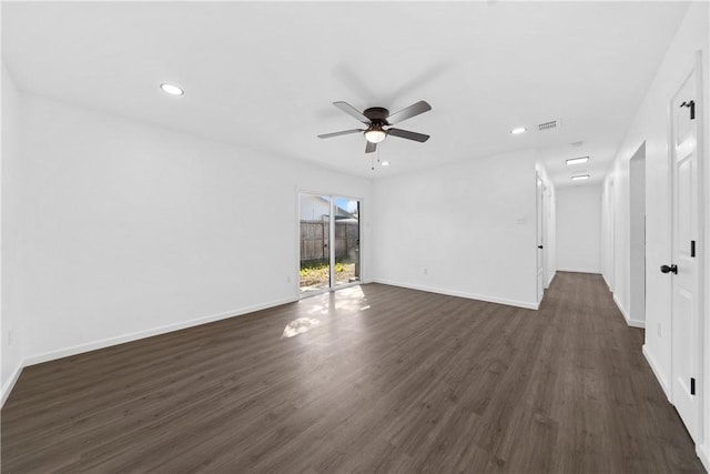 spare room featuring dark wood-type flooring and ceiling fan