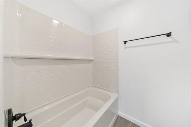 bathroom with wood-type flooring and bathing tub / shower combination