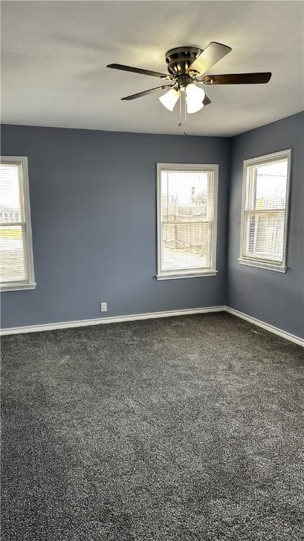 empty room with a ceiling fan, baseboards, and carpet flooring