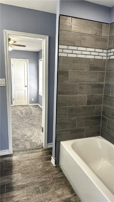 full bathroom featuring baseboards, a ceiling fan, shower / washtub combination, and wood finished floors