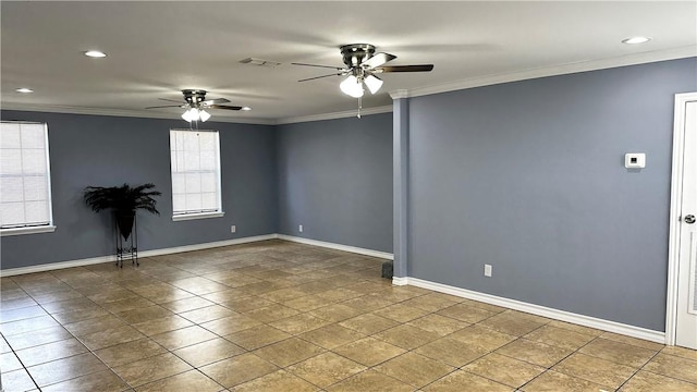 empty room with ornamental molding, visible vents, ceiling fan, and baseboards