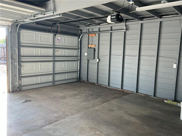 garage with electric panel and a garage door opener