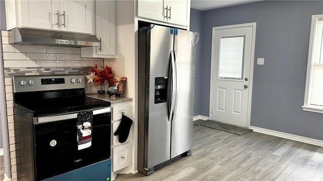 kitchen featuring light wood finished floors, tasteful backsplash, stainless steel appliances, under cabinet range hood, and white cabinetry