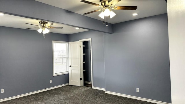 empty room with a ceiling fan, recessed lighting, dark carpet, and baseboards