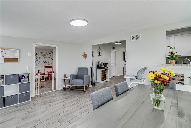 dining space featuring light wood-type flooring