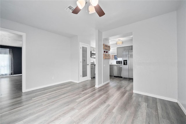 unfurnished living room with light hardwood / wood-style flooring and ceiling fan