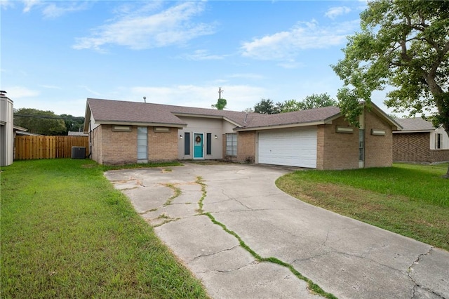 ranch-style home featuring a garage, central air condition unit, and a front lawn