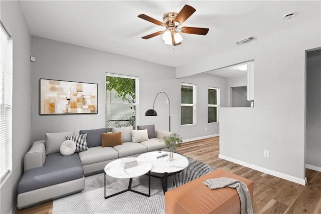 living room featuring a healthy amount of sunlight, hardwood / wood-style flooring, and ceiling fan