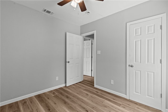 unfurnished bedroom with light hardwood / wood-style floors and ceiling fan