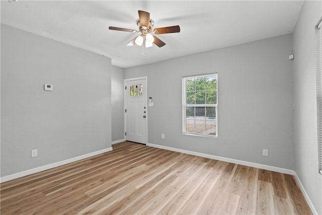 spare room with light hardwood / wood-style flooring and ceiling fan