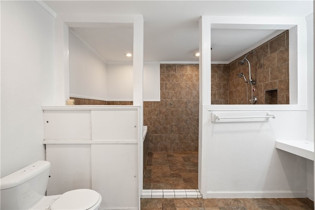 bathroom with toilet and tiled shower