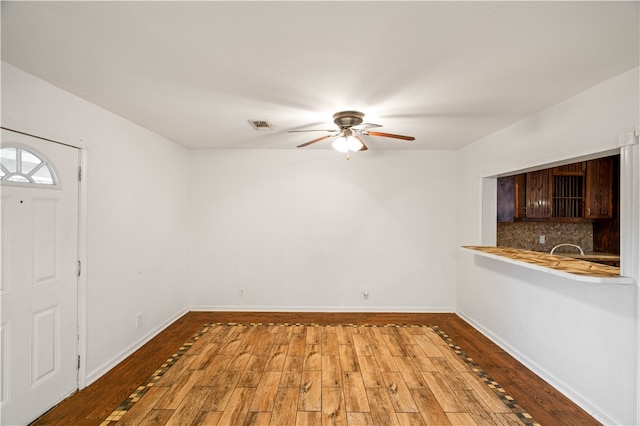 unfurnished dining area with wood-type flooring and ceiling fan