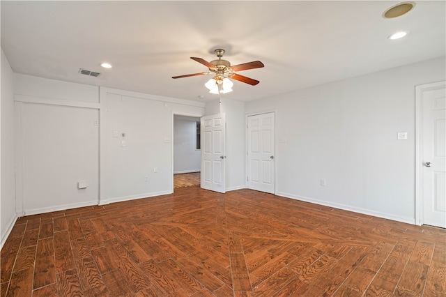 unfurnished room featuring ceiling fan and dark hardwood / wood-style flooring