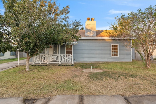 view of front of house with a front lawn and a porch