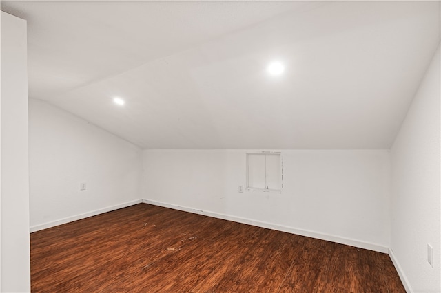 additional living space with dark hardwood / wood-style floors and lofted ceiling