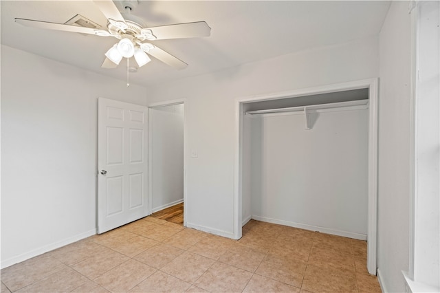 unfurnished bedroom with ceiling fan, light tile patterned floors, and a closet