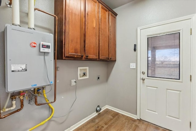 laundry area featuring hookup for a washing machine, cabinet space, water heater, hookup for an electric dryer, and wood finished floors