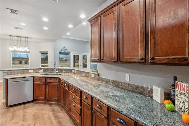 kitchen featuring a sink, stone countertops, visible vents, and stainless steel dishwasher