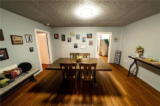 dining space featuring a textured ceiling and wood finished floors