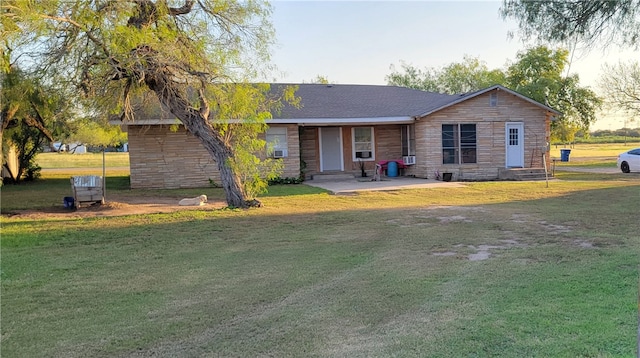 rear view of house featuring stone siding and a lawn