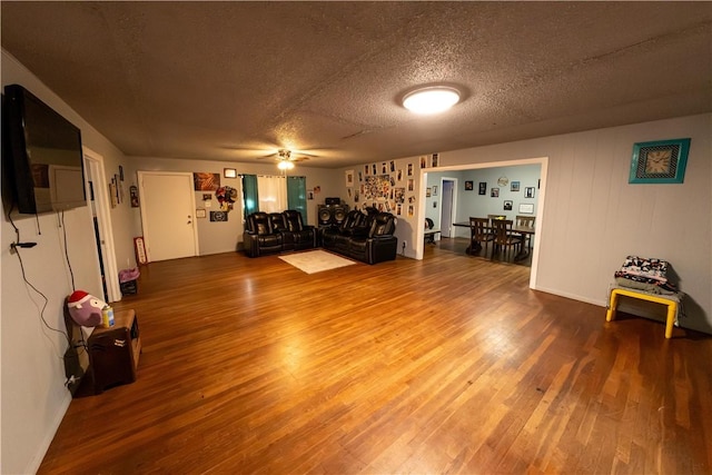 interior space featuring a textured ceiling, wood finished floors, and a ceiling fan