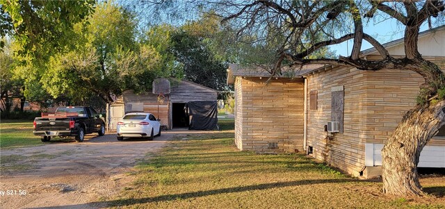 view of home's exterior featuring an outbuilding and a lawn