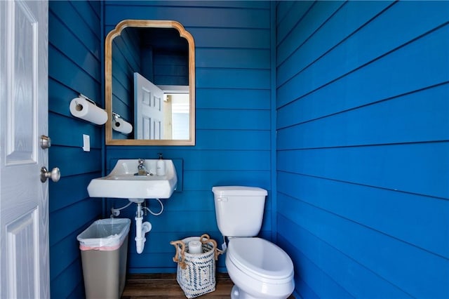 bathroom featuring hardwood / wood-style flooring, toilet, and sink