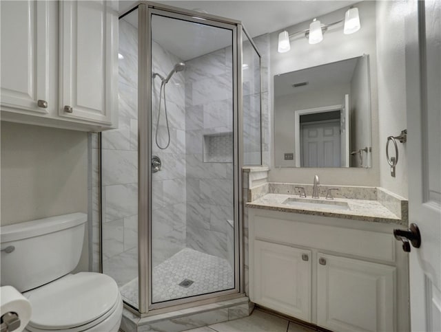 bathroom featuring toilet, visible vents, a stall shower, and vanity