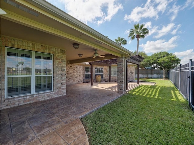 view of yard with ceiling fan, a patio, a fenced backyard, and a pergola