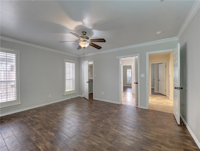 unfurnished room with ceiling fan, dark wood-type flooring, baseboards, and crown molding